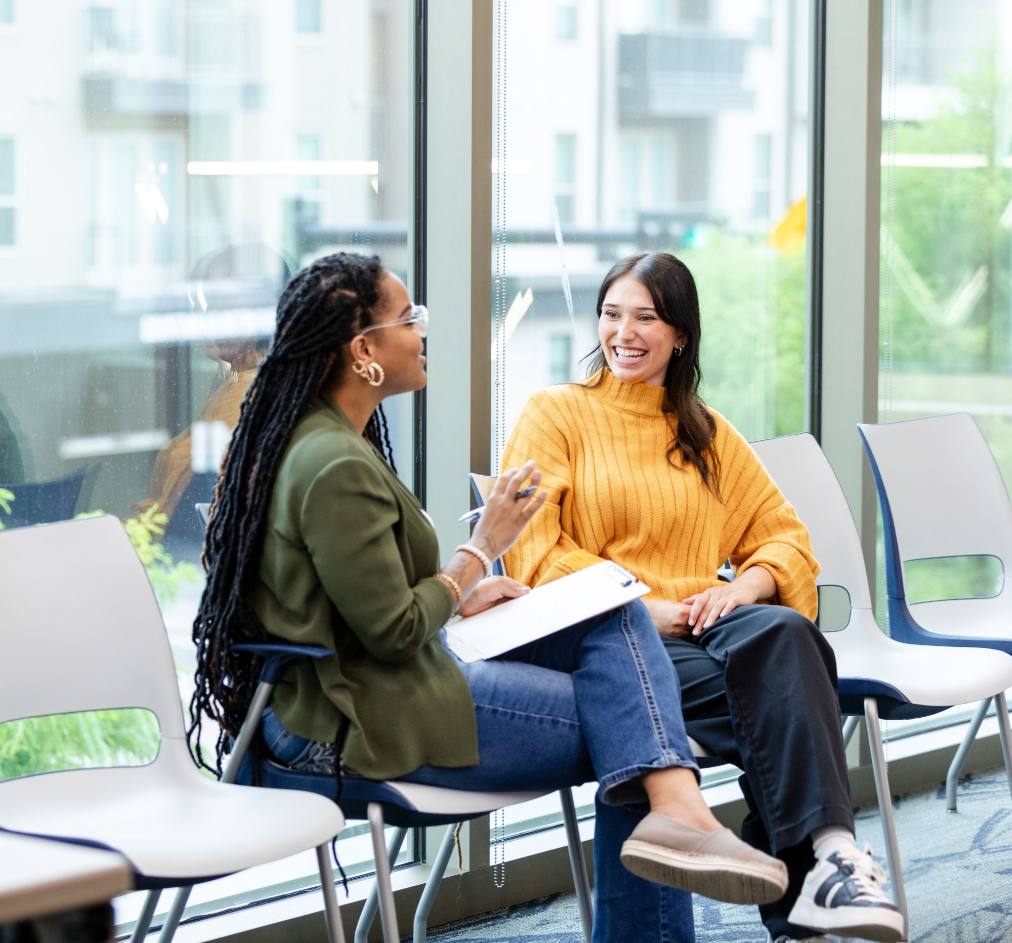 Picture of two women talking in a healthcare setting.